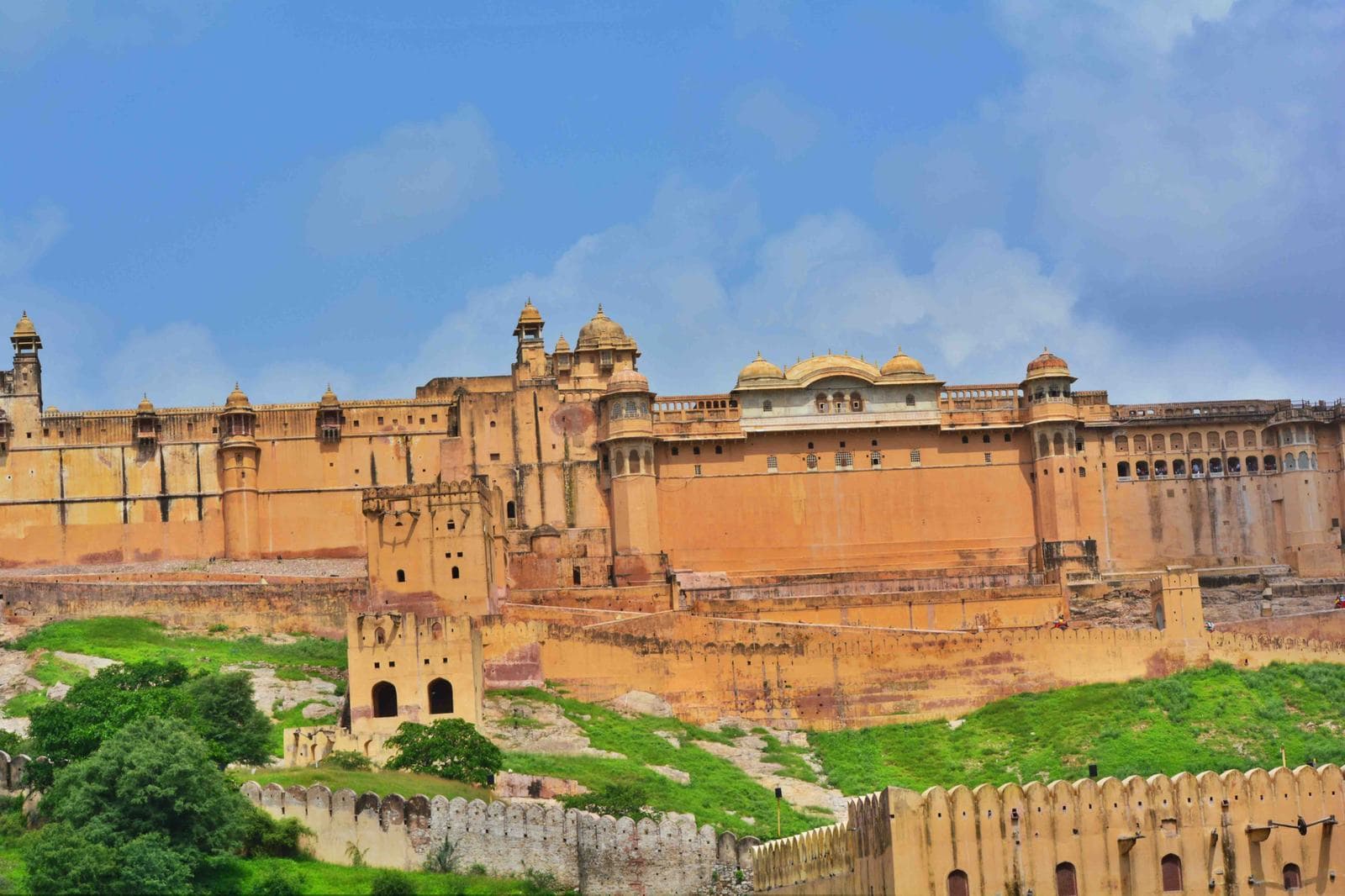 The ramparts and palace buildings of Amber Fort, Jaipur, on the hillside above Maota Lake